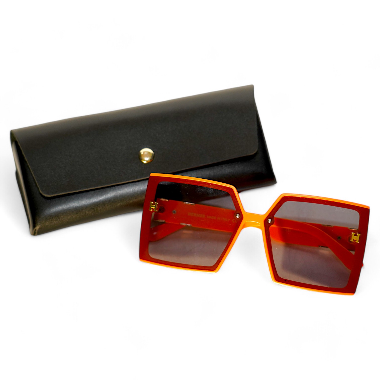 A pair of orange Hermes sunglasses